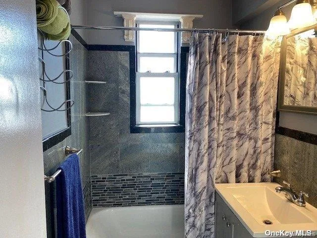 a bathroom with a sink and a shower curtain