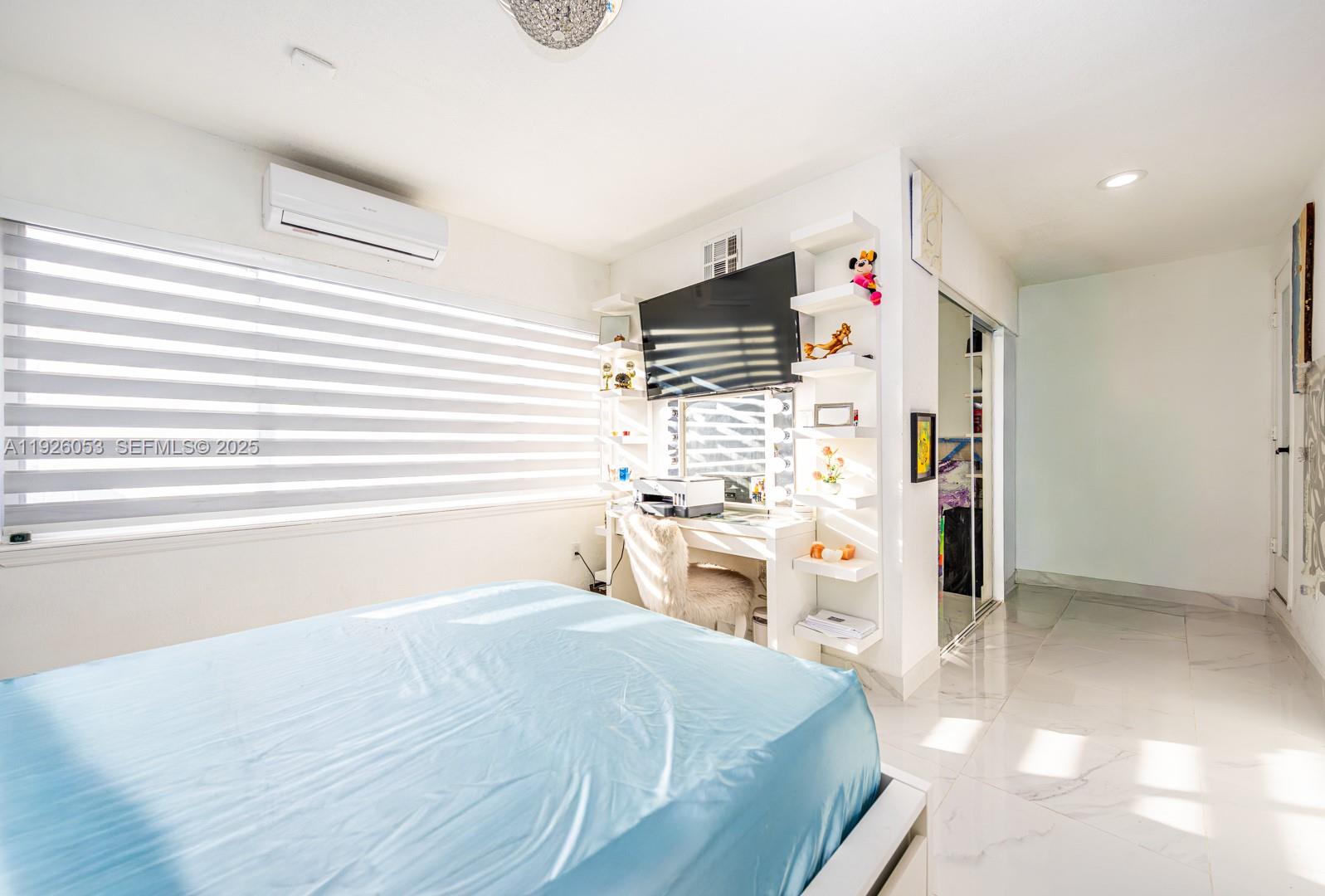 9365 Southwest 44th Street Miami, FL 33165 - Photo 13 of 24 a room with a bed and a kitchen view