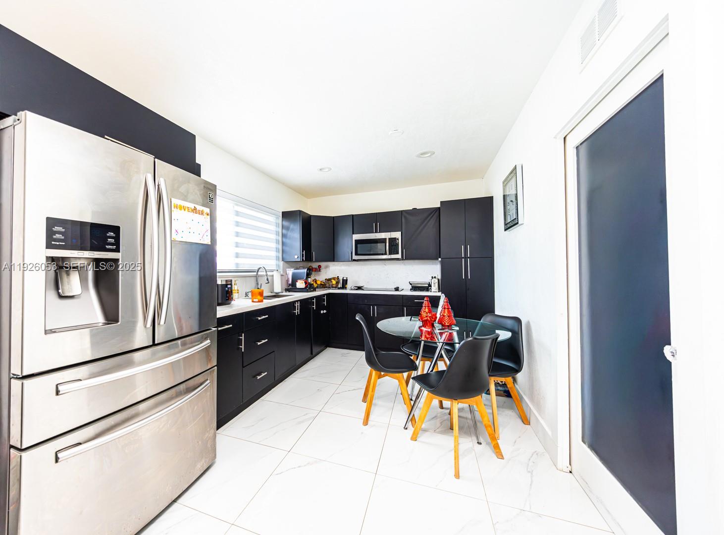 9365 Southwest 44th Street Miami, FL 33165 - Photo 17 of 24 a kitchen with stainless steel appliances kitchen island granite countertop a refrigerator and a stove top oven
