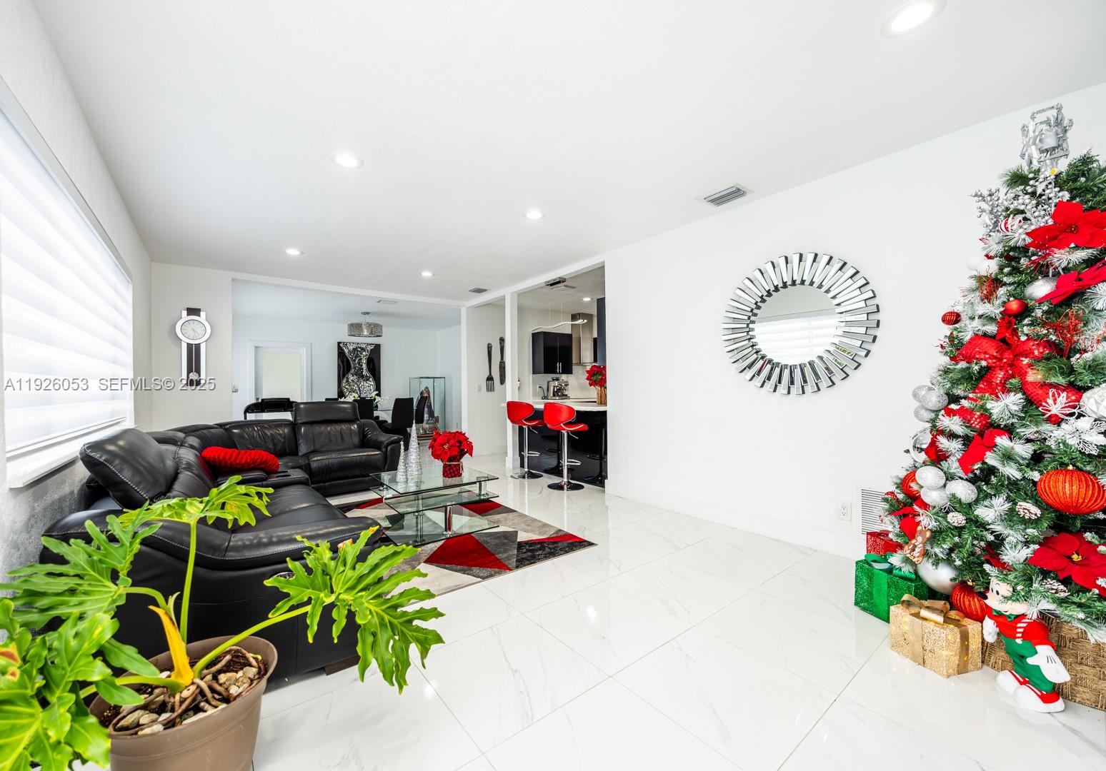 9365 Southwest 44th Street Miami, FL 33165 - Photo 7 of 24 a living room filled with furniture and a chandelier