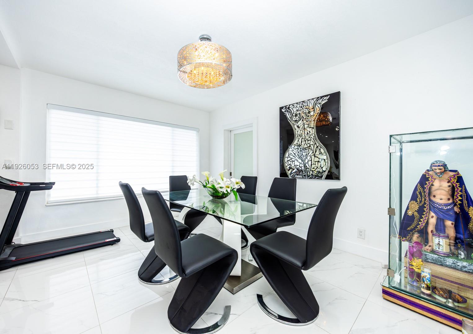 9365 Southwest 44th Street Miami, FL 33165 - Photo 9 of 24 a view of a dining room with furniture and a potted plant