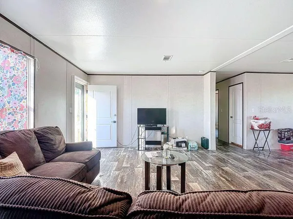 a view of a dining room with furniture and wooden floor