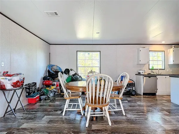 a kitchen with sink cabinets and wooden floor