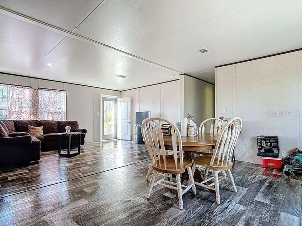 a kitchen with refrigerator cabinets and wooden floor