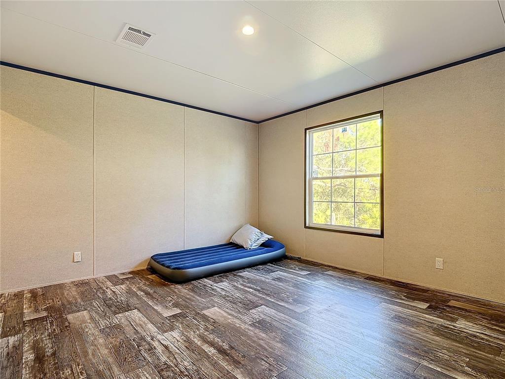 8325 Strasse Boulevard Punta Gorda, FL 33982 - Photo 30 of 57 a bedroom with a bed and a window