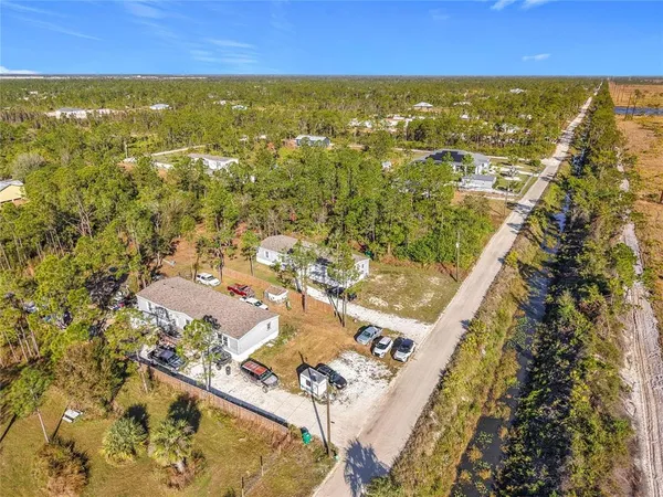 an aerial view of residential houses with outdoor space