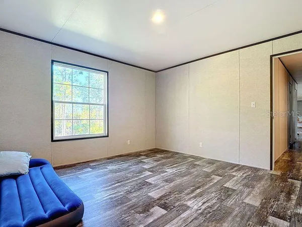 a bathroom with a granite countertop sink and a toilet