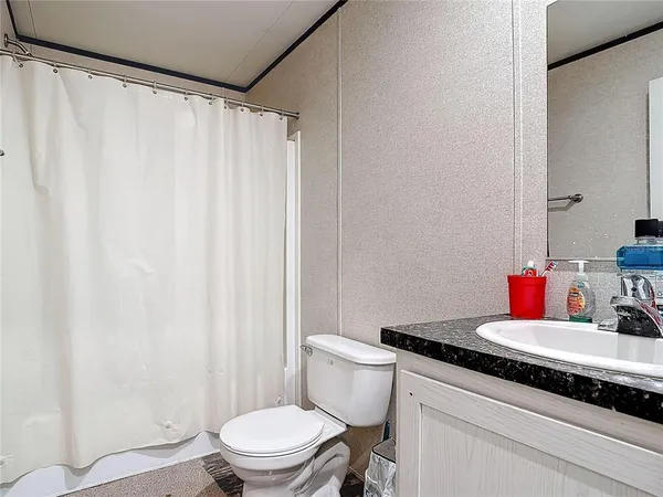 a bedroom with a bed and a chair