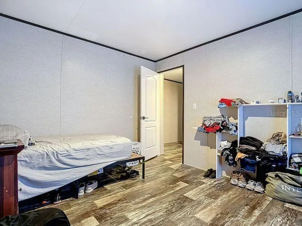 a bedroom with a bed and a book shelf