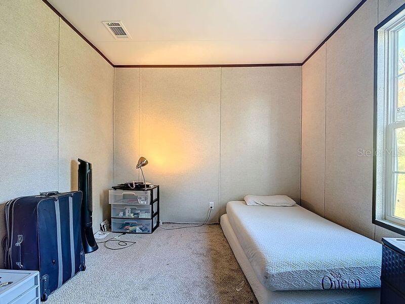 8325 Strasse Boulevard Punta Gorda, FL 33982 - Photo 42 of 57 a bedroom with a bed and a book shelf