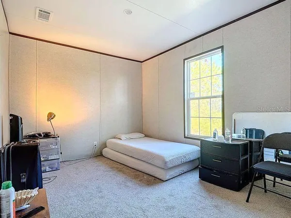a bedroom with furniture and a wooden floor