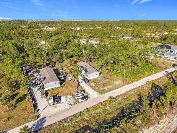 an aerial view of residential houses with outdoor space