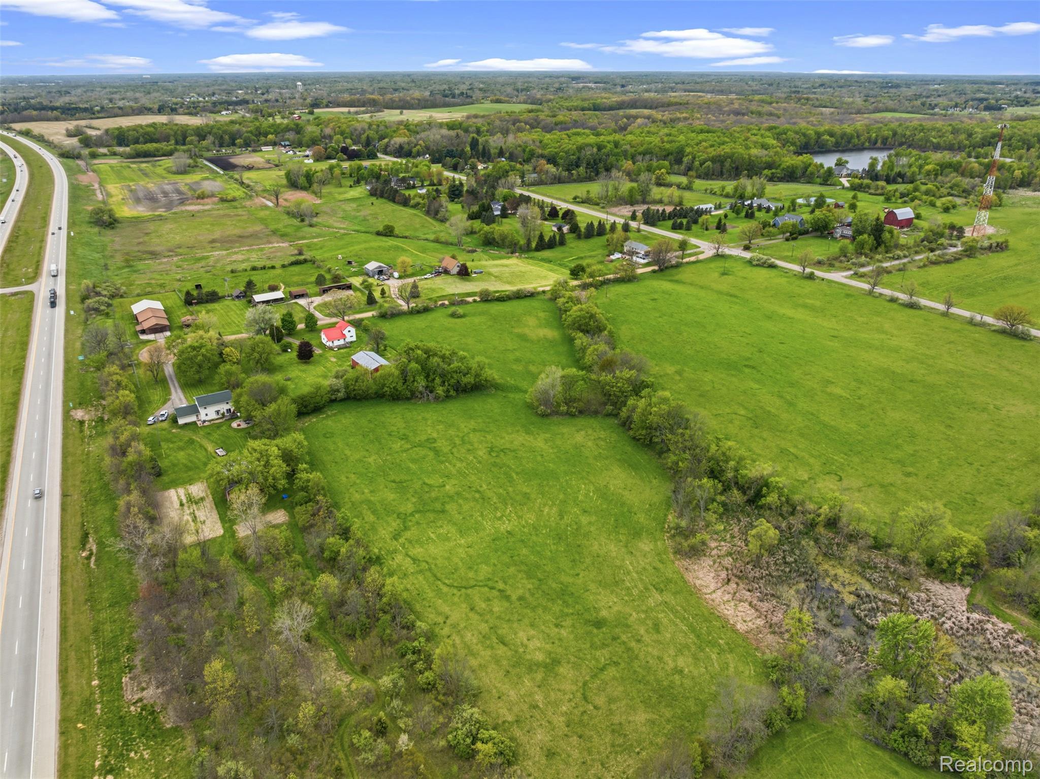 1145 South Washburn Road Lapeer, MI 48446 - Photo 47 of 56 Aerial view of sparsely populated area with a nearby body of water