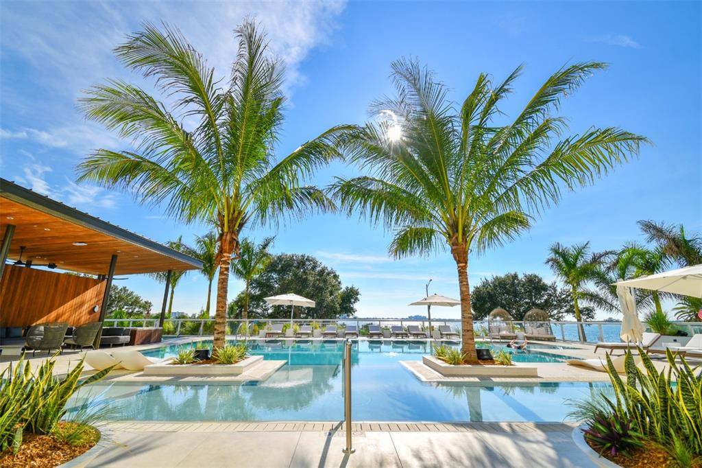 1020 Sunset Point Road, Unit 605 Clearwater, FL 33755 - Photo 5 of 35 a view of swimming pool with outdoor seating and lounge chair