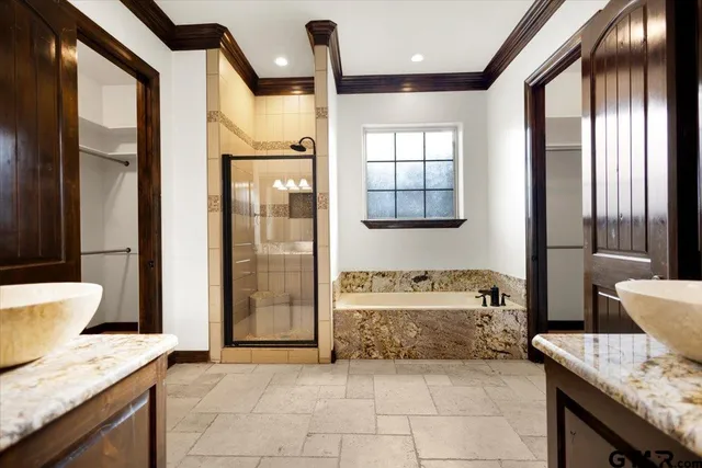 a bathroom with a granite countertop sink a toilet and shower