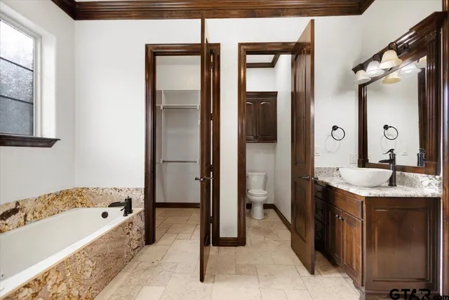 a bathroom with a tub sink and mirror