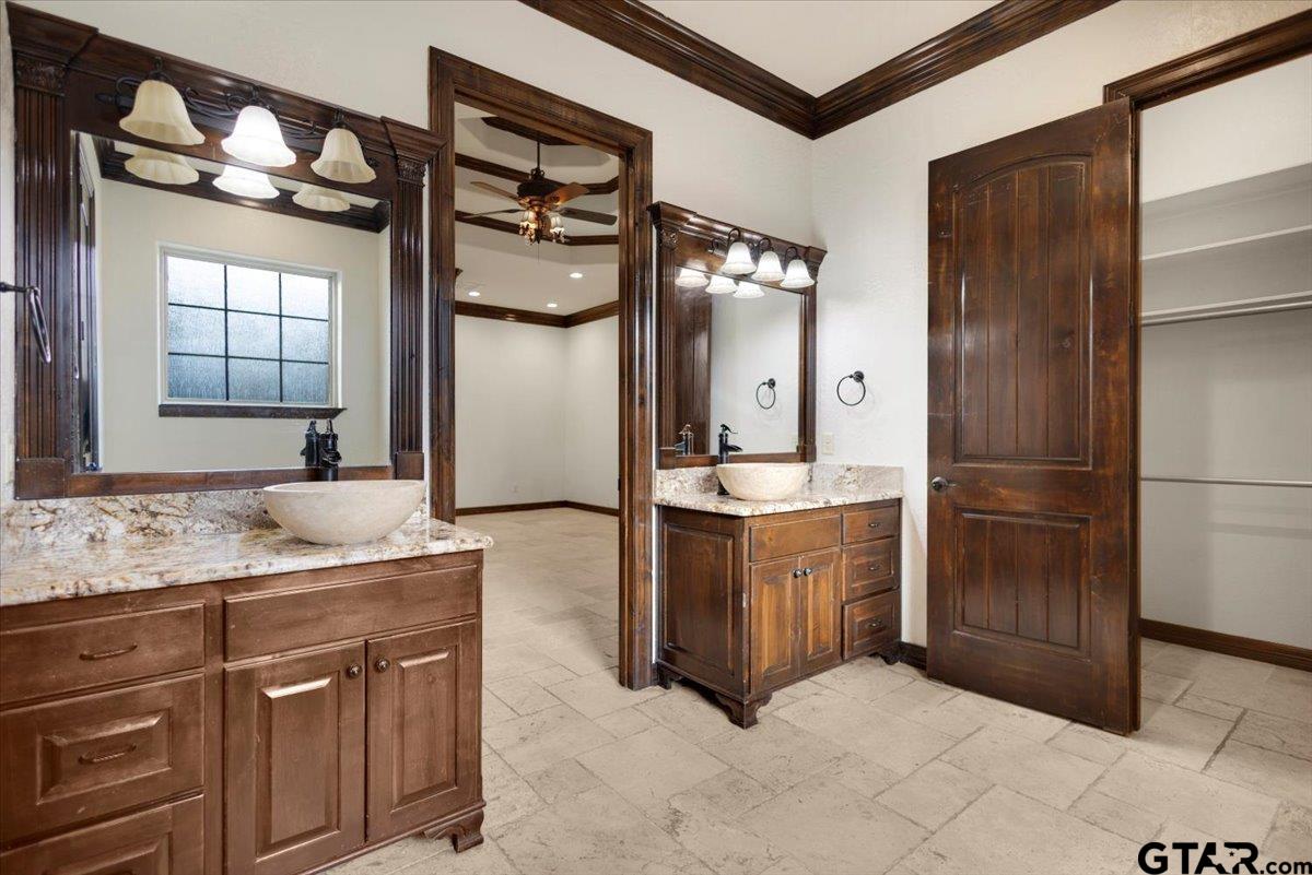 7750 Highway 110 Tyler, TX 75704 - Photo 13 of 31 a bathroom with a granite countertop sink a mirror and shower