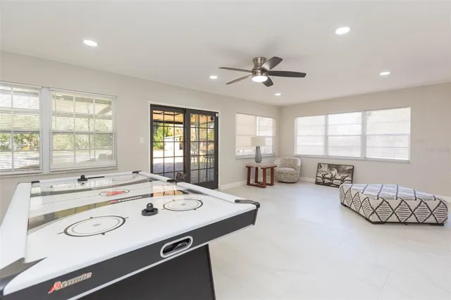 a large white kitchen with a large window
