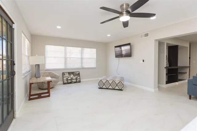a living room with furniture and a large window