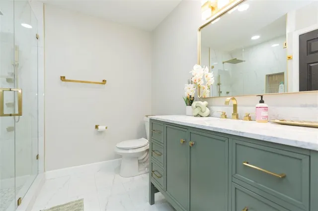 a bathroom with a sink a toilet and a mirror