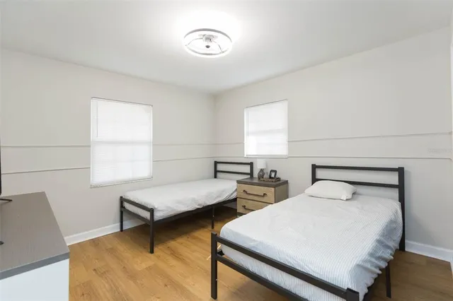 a bedroom with two beds and a window