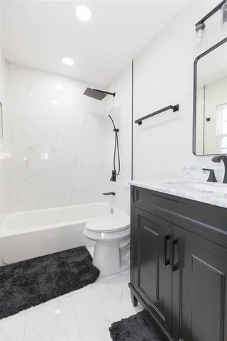 a bathroom with a sink a toilet and bathtub