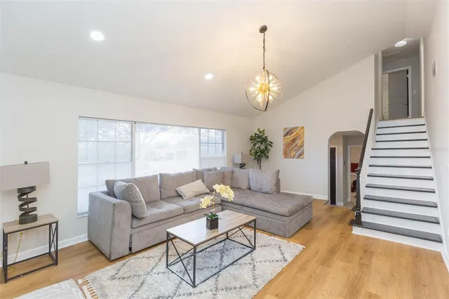 a living room with furniture and a chandelier