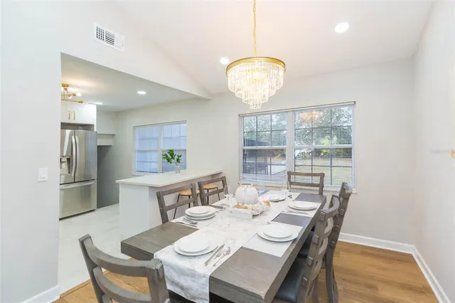 a view of a dining room with furniture wooden floor and chandelier