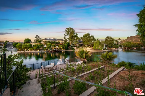 a view of a lake with houses in the back