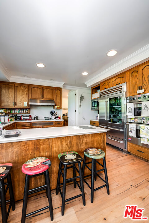 10061 Valley Spring Lane Toluca Lake, CA 91602 - Photo 16 of 37 a large kitchen with a table and chairs