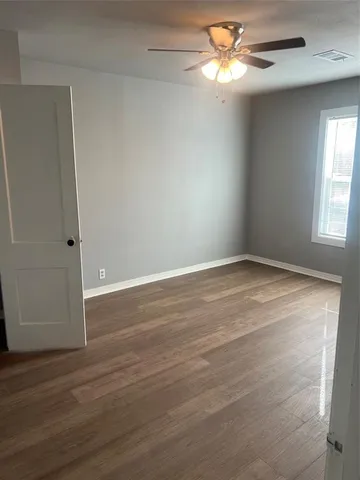 a view of room with window and ceiling fan