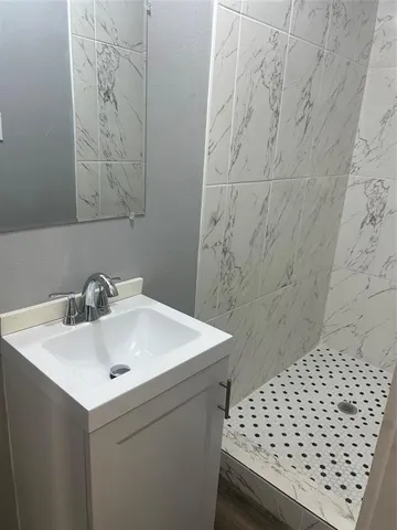 a bathroom with a sink a toilet and a shower