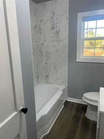 a bathroom with a bathtub and a toilet