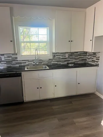 a kitchen with granite countertop white cabinets and a granite counter tops