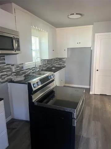 a kitchen that has a sink and a stove