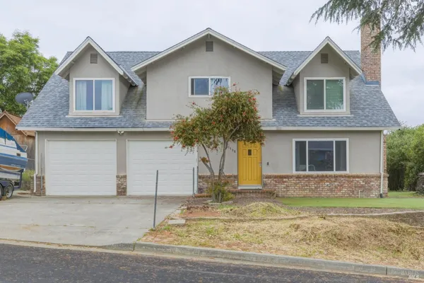 a front view of a house with a yard and garage