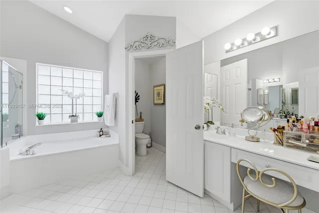 a bathroom with a tub sink and mirror