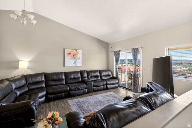 161 West 950 South, Unit Q1 St. George, UT 84770 - Photo 12 of 37 Living area with lofted ceiling, suspended lighting, and wood finished floors