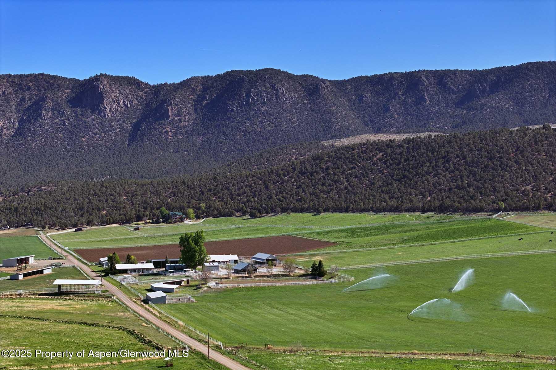 10676 Bostwick Park Road Montrose, CO 81401 - Photo 18 of 42 a view of a golf course with chairs