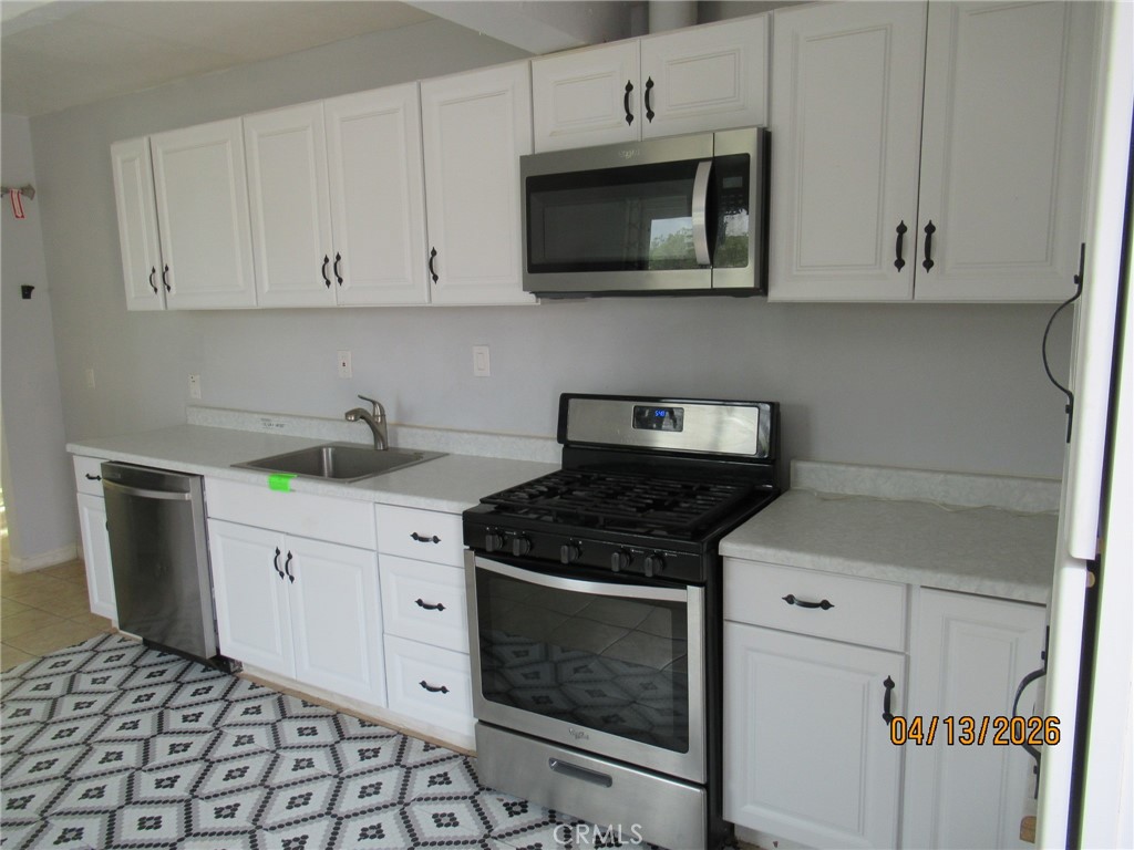 37650 Tripp Flats Road Anza, CA 92539 - Photo 7 of 8 a kitchen with stainless steel appliances granite countertop white cabinets a sink and dishwasher