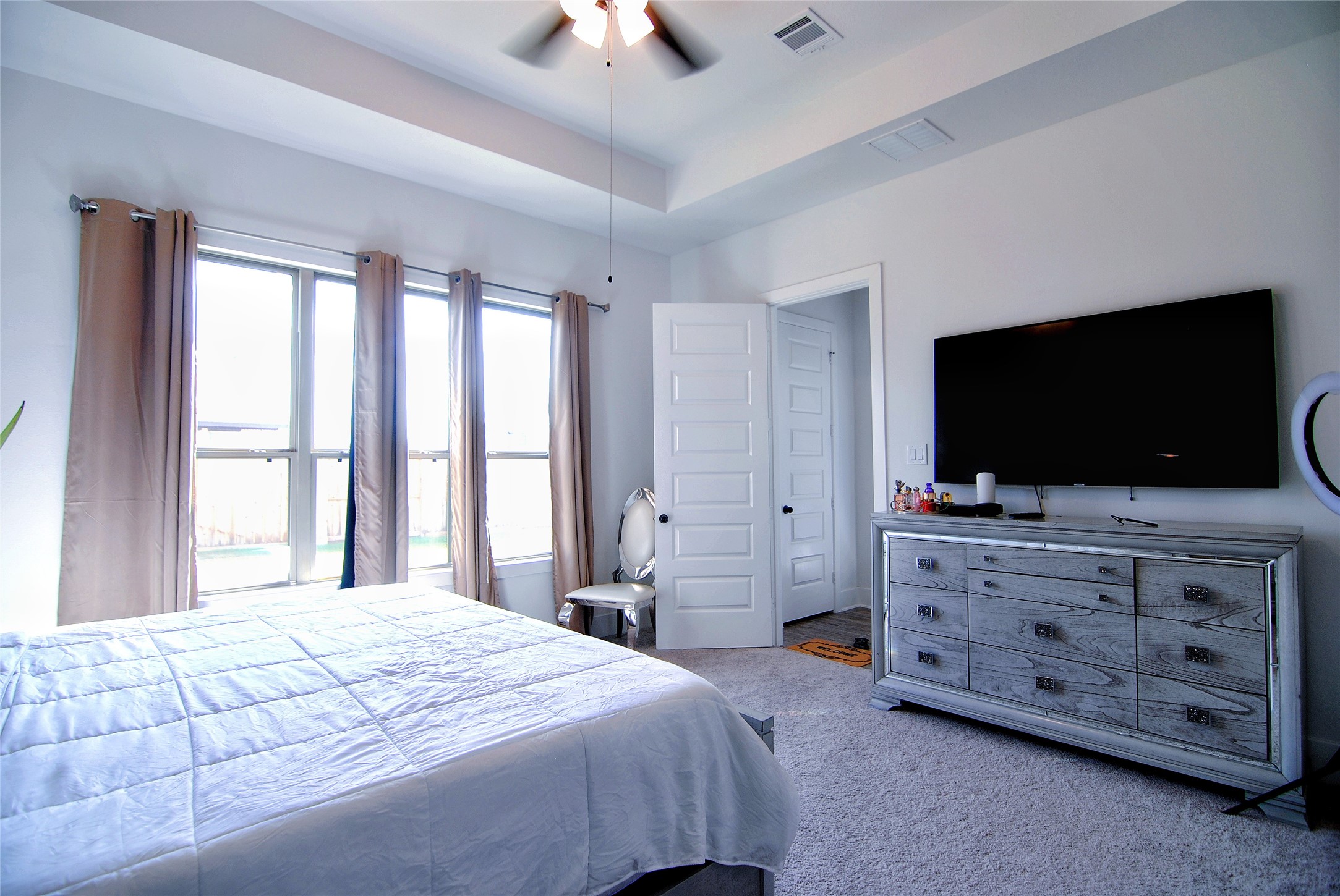 31447 Golden Cliffs Lane Fulshear, TX 77441 - Photo 20 of 45 a bedroom with a bed and a flat screen tv