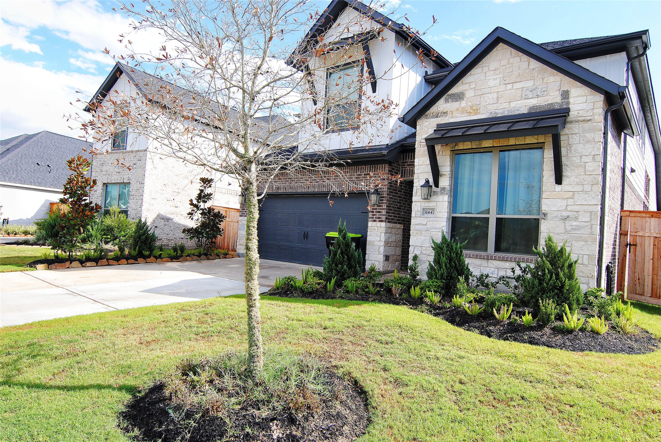 31447 Golden Cliffs Lane Fulshear, TX 77441 - Photo 2 of 45 a view of a house with backyard and garden
