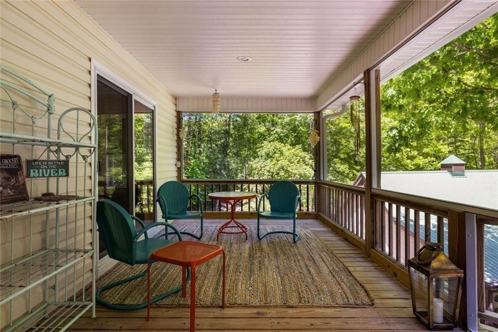 704 Riverbend Road Blairsville, GA 30512 - Photo 26 of 89 a balcony with wooden floor table and chairs