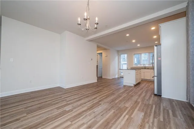 a view of a kitchen with wooden floor and a kitchen