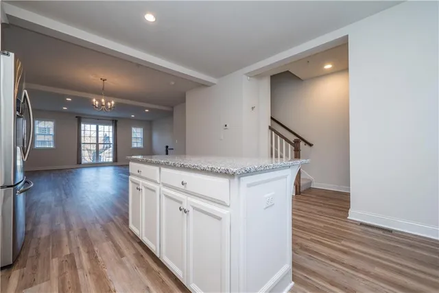 a view of livingroom with kitchen and wooden floor