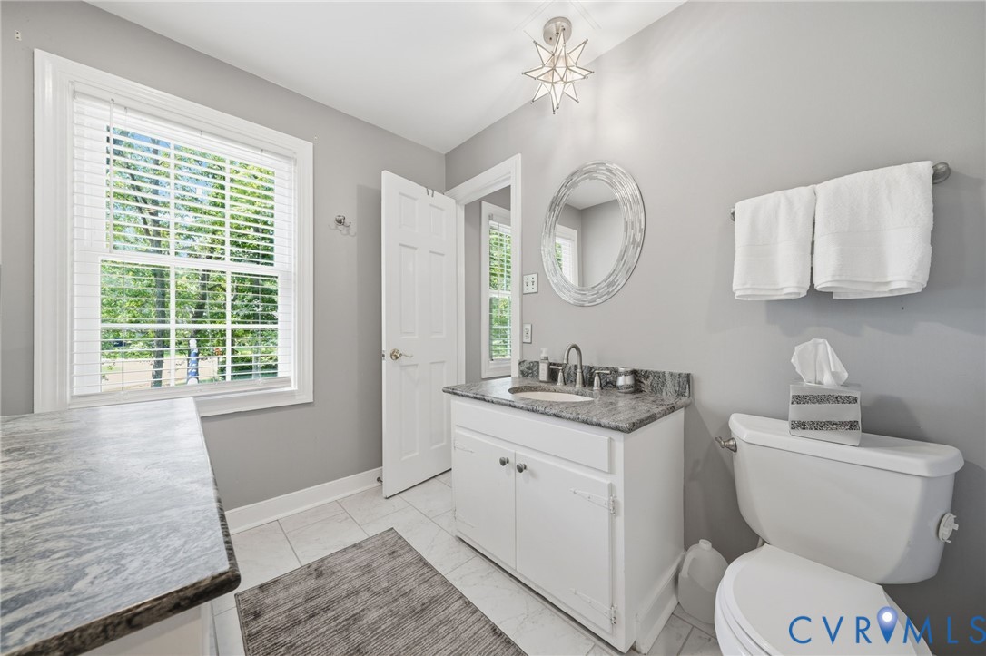 2101 Castlebridge Road Midlothian, VA 23113 - Photo 22 of 37 a bathroom with a granite countertop toilet sink and mirror