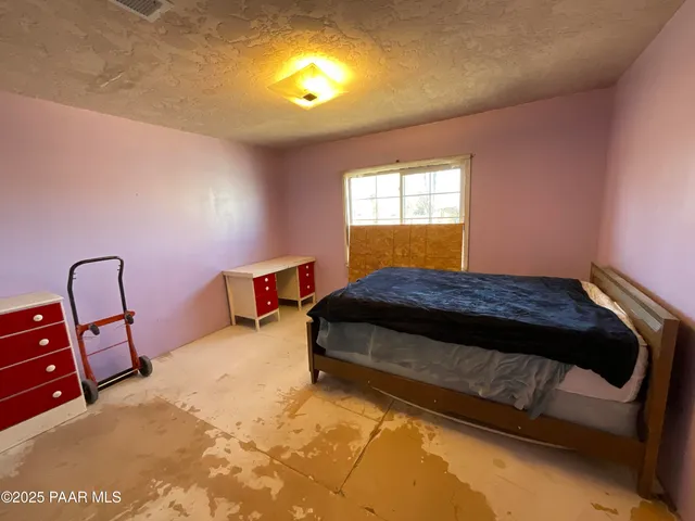 a bedroom with a bed and a mirror