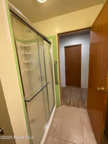 a bathroom with a granite countertop toilet and a sink