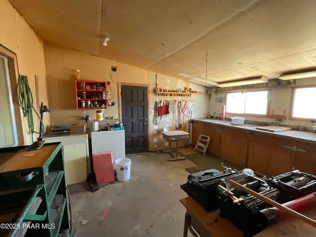 a view of a dirt road with a building in the background