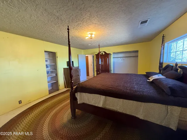 a bed room with a bed and a night stand